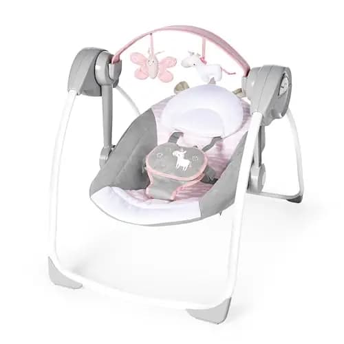 Ingenuity, Columpio Compacto y Plegable Flora el Unicornio, 6 velocidades de balanceo, temporizador, 12 melodías, arco de juegos extraíble, rosa, desde recién nacido hasta los 9 kg, 1 Unidad